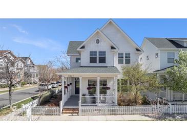 Charming two-story home featuring white siding, a cozy front porch, and a picket fence at 11687 Newton St, Westminster, CO 80031
