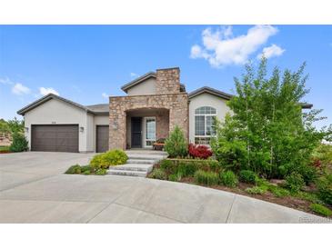 Charming home with a stone-accented entrance and well-maintained landscaping at 5608 Raintree Dr, Parker, CO 80134