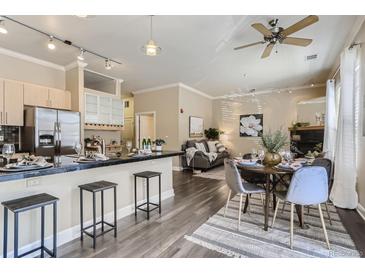 Open-concept living space with modern kitchen, dining area, and comfortable seating, perfect for entertaining and relaxation at 5677 S Park Pl # C111, Englewood, CO 80111