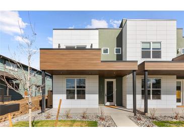 Modern home featuring multi-tone exterior, with a covered porch and decorative stone landscaping at 2466 S Cherokee St, Denver, CO 80223