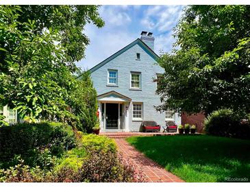 Charming painted brick home with a landscaped front yard and a welcoming brick pathway at 428 N Humboldt St, Denver, CO 80218
