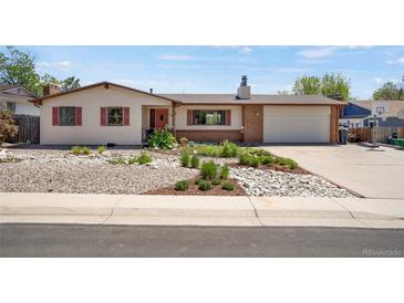 Charming ranch-style home featuring a manicured yard, brick accents, and a convenient two-car garage at 330 Johnson Dr, Castle Rock, CO 80104
