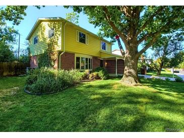 Beautiful two-story home with a spacious yard and mature trees at 7024 E Montana Pl, Denver, CO 80224