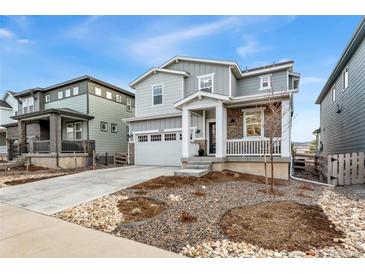 Charming two-story home with a well-manicured lawn and a two-car garage in a Gathering-friendly neighborhood at 8480 Arriba Dr, Littleton, CO 80125