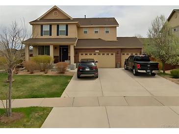 Two-story house with attached two-car garage and landscaped yard at 492 N Jackson Gap Way, Aurora, CO 80018