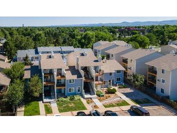 An aerial view of modern condos and a well-maintained landscape on a sunny day at 6007 Yarrow St # D, Arvada, CO 80004