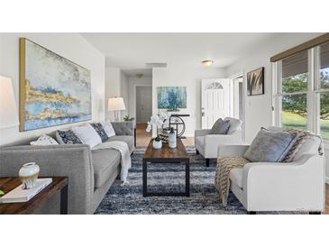 Bright and airy living room featuring modern decor and comfortable seating arrangement at 46531 Sundance Trl, Parker, CO 80138