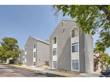 Exterior view of gray townhouse complex with white accents at 3436 S Locust St # D, Denver, CO 80222