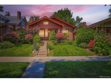 Charming brick home with beautiful landscaping, green lawn, and inviting curb appeal at 2541 Bellaire St, Denver, CO 80207