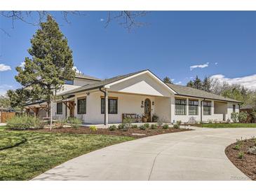 Inviting single-story home featuring a quaint covered porch and fresh landscaping at 6102 S Aberdeen St, Littleton, CO 80120