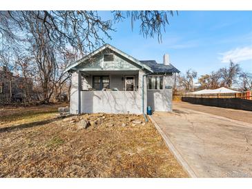 Brick house with front porch and driveway, offering curb appeal at 6145 W 38Th Ave, Wheat Ridge, CO 80033