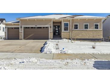 Two-story house with light beige siding, stone accents, and a two-car garage at 4704 Twelve Oaks Way, Castle Rock, CO 80104