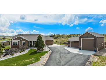 Beautiful home featuring a long driveway leading to an attached and detached garage at 555 Heritage Trl, Elizabeth, CO 80107