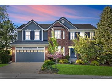 Charming two-story home featuring brick and siding, complemented by a well-maintained lawn and professional landscaping at 17925 E Maplewood Dr, Aurora, CO 80016