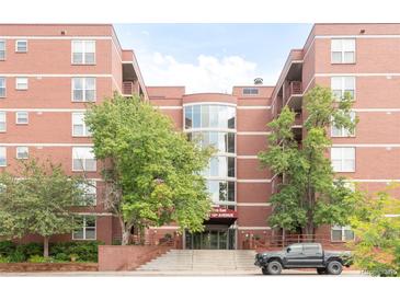 An exterior shot of a brick apartment building with well-maintained landscaping at 5955 E 10Th Ave # 507, Denver, CO 80220