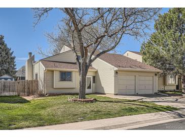Charming home with a two-car garage, manicured lawn, and mature landscaping at 4272 E 126Th Pl, Thornton, CO 80241