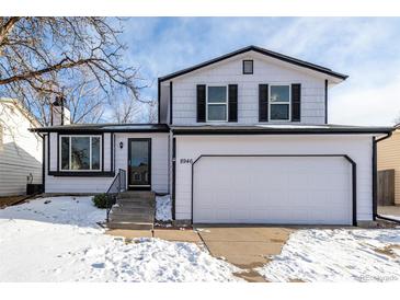 Two-story house with white siding, a two-car garage, and a snow-covered front yard at 8946 W Teton Cir, Littleton, CO 80128