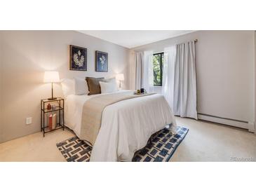 Bright bedroom featuring a comfortable bed, stylish decor, and a window with natural light at 7770 W 38Th Ave # 207, Wheat Ridge, CO 80033