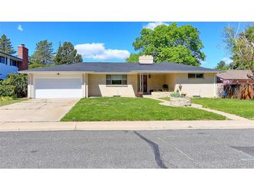 Charming brick home with a well-maintained lawn and attached two-car garage under a clear blue sky at 3375 Zephyr Ct, Wheat Ridge, CO 80033