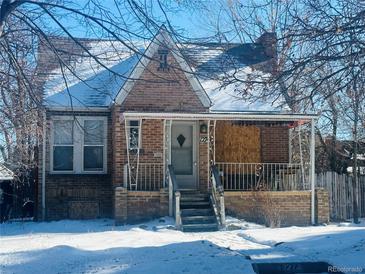 Brick home with covered porch and steps, needs repairs at 1274 Hudson St, Denver, CO 80220