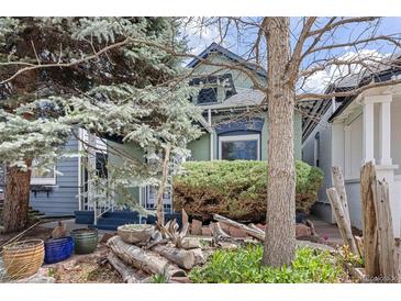 Charming home exterior with mature trees and landscaping that provides wonderful curb appeal at 2514 N Humboldt St, Denver, CO 80205