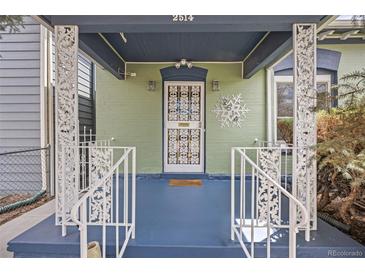 Charming front porch with decorative railings and blue painted floor offers a welcoming entrance at 2514 N Humboldt St, Denver, CO 80205