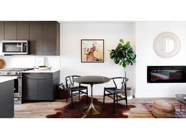 Stylish dining area with a round table, modern art, and elegant decor at 1168 S Reed Way, Lakewood, CO 80232