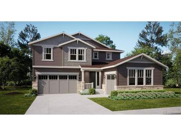 Charming two-story home with a three car garage and professionally landscaped yard at 85 Wooten Ave, Brighton, CO 80601