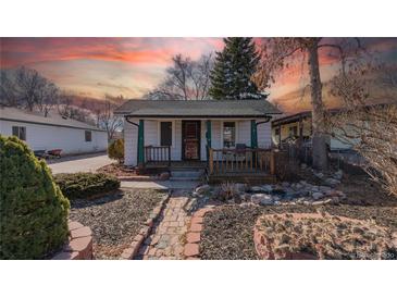 Charming bungalow with a cozy front porch, desert xeriscape and brick walkway at 437 Raleigh St, Denver, CO 80204