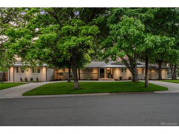 Charming single-story home with a well-manicured front lawn and mature trees at 3901 S Dexter St, Cherry Hills Village, CO 80113