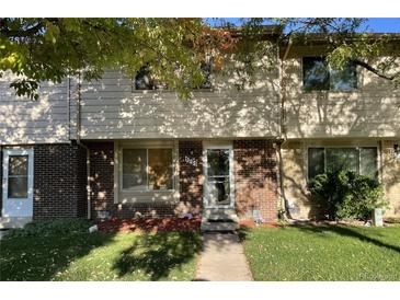 Tan brick townhouse with a small front yard and walkway at 1227 S Uvalda St, Aurora, CO 80012