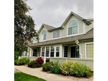 Charming townhome exterior with large windows and well-maintained landscaping at 1124 E 130Th Ave # C, Thornton, CO 80241