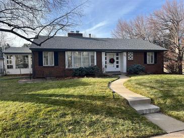 Brick ranch home with landscaped lawn and walkway at 701 S Clayton St, Denver, CO 80209