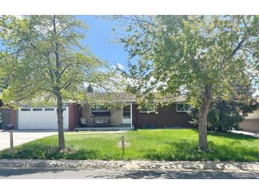 Charming brick home with a well-manicured lawn and mature trees in a tranquil neighborhood at 13024 E Alaska Pl, Aurora, CO 80012