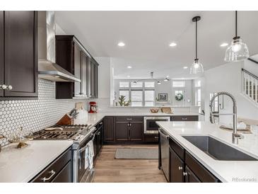 Gourmet kitchen features stainless steel appliances and white backsplash, perfect for cooking and entertaining at 11027 Sunshimmer Cir, Parker, CO 80134