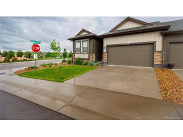 Modern two-car garage home with landscaped front yard at 11860 Sandcastle Ct, Parker, CO 80138