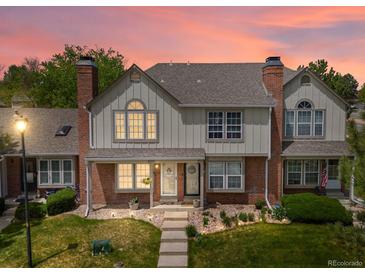 Charming townhome boasts a well-maintained lawn, brick accents, and a cozy, inviting entrance at 9676 W Chatfield Ave # B, Littleton, CO 80128
