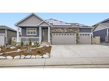 Charming home featuring stone accents, solar panels and a spacious three car garage at 6711 Fraser Cir, Frederick, CO 80530