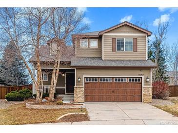 Charming two-story home featuring a well-maintained front yard and attached two-car garage at 10358 Kelliwood Way, Highlands Ranch, CO 80126