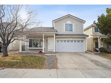 Charming two-story home featuring a covered porch and a two-car garage, perfect for Gathering living at 4865 Gibraltar St, Denver, CO 80249