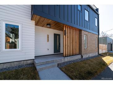 Modern exterior with a combination of textures and colors featuring a welcoming porch and sleek design elements at 3432 W 25Th Ave, Denver, CO 80211
