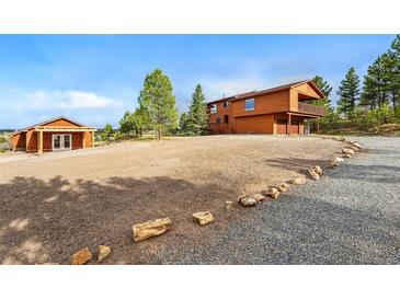 Charming wooden home with a spacious yard and a detached garage at 2100 Bibles Hill Dr, Franktown, CO 80116
