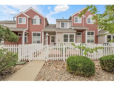 Charming townhome with a white picket fence and well-maintained landscaping in a desirable neighborhood at 843 Snowberry St, Longmont, CO 80503