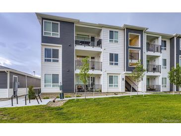 Modern apartment building with a striking two-tone color scheme and private balconies at 6153 N Ceylon St # 2-202, Denver, CO 80249