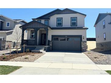 Charming two-story home features a covered porch, two-car garage, and low maintenance landscaping at 11008 Snowdon St, Parker, CO 80134
