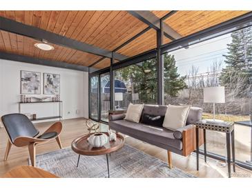 Bright living room with wood ceilings, hardwood floors and large windows offering lots of natural light at 330 W Fair Ave, Littleton, CO 80120