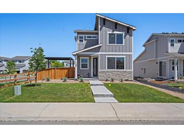 Charming two-story home featuring gray siding, stone accents, a well-maintained lawn, and inviting curb appeal at 1100 Blue Bell Rd, Berthoud, CO 80513