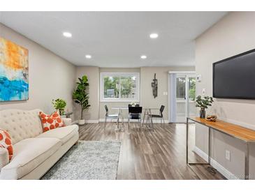 Bright living room features hardwood floors, contemporary decor, and ample natural light at 2856 S Kenton Ct, Aurora, CO 80014