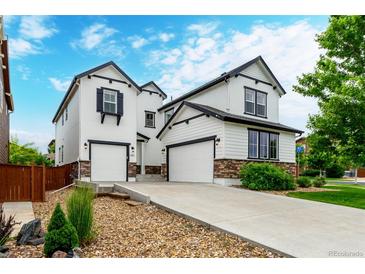 Charming two-story home features a two-car garage, stone accents, and a well-manicured lawn and driveway at 690 W 172Nd Pl, Broomfield, CO 80023