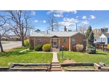 Charming brick home featuring a well-maintained lawn and inviting front entrance at 1299 S Dale Ct, Denver, CO 80219